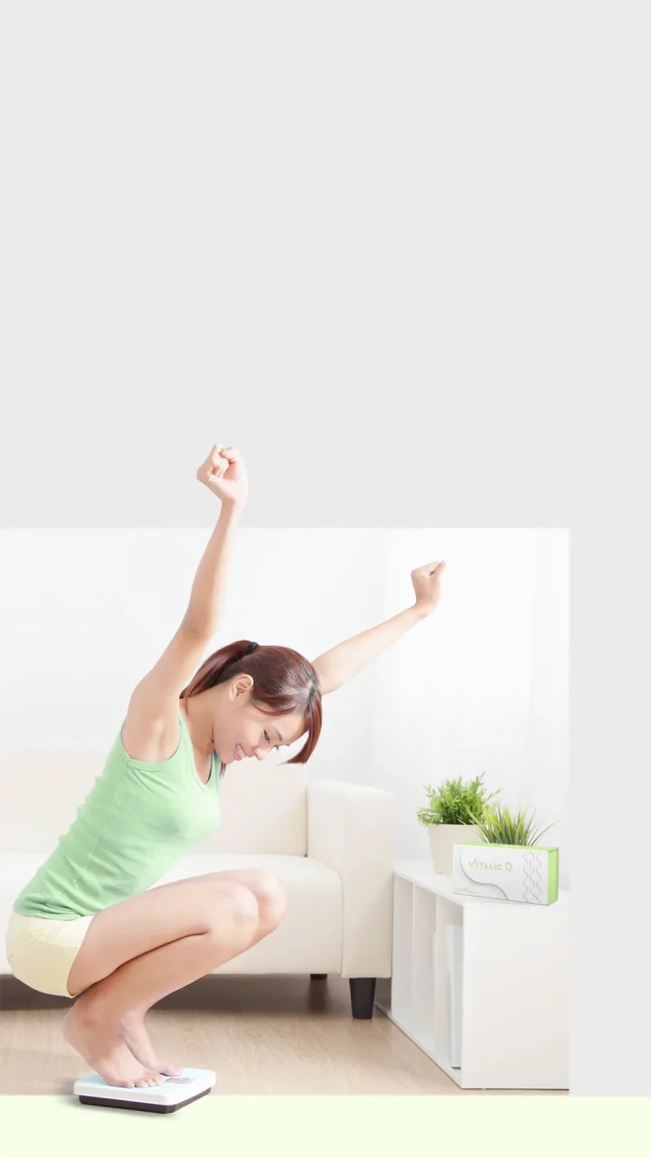 Pretty girl read the weighing result happily after complete colon cleanse for weight loss and reshape body alignment at home