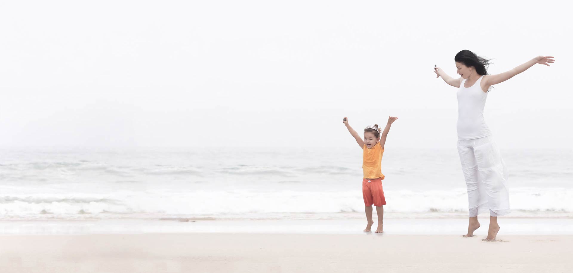 Mother and daughter enjoy optimal health eternal happiness at beach after healthy colon cleanse